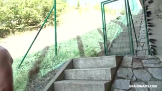 omg that skinny granny is dominating and fucking her twink slave outdoors! 😈👵