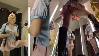 In a bustling dressing room, a hidden camera captures an upskirt view of a blonde amateur's juicy pussy as she tries on clothes