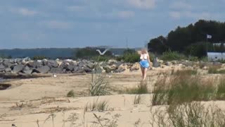 Feeling the Heat: Curvy Blonde in White Swimsuit on Beach