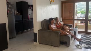 she's in the living room with her friend while he's in the kitchen