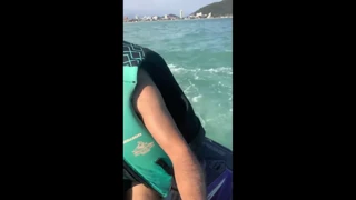 What activity occurs between a young woman and an instructor on a jet ski (EroZyx)?