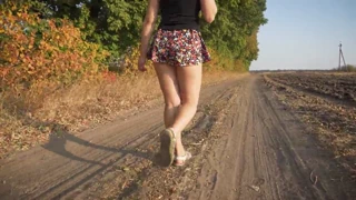 Girl walks outdoors, showing upskirt full back panties