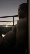 Sexy brunette nysdel performs on hotel balcony as couple
