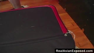 petite asian opens suitcase and shows her body for you