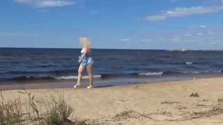 Feeling the Heat: Curvy Blonde in White Swimsuit on Beach